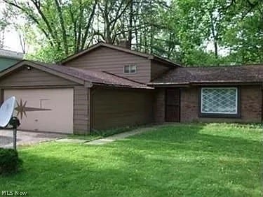 133 Fell Ave, Northfield, OH 44067 - exterior space with a garage and a front yard
