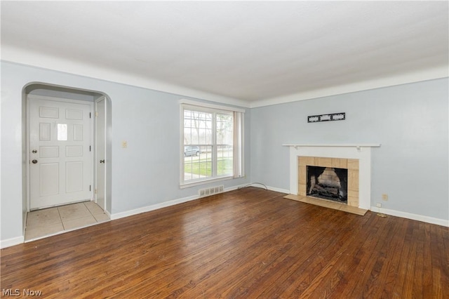 unfurnished living room featuring a fireplace and light hardwood / wood-style flooring