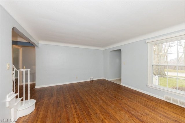 empty room featuring hardwood / wood-style flooring and a wealth of natural light