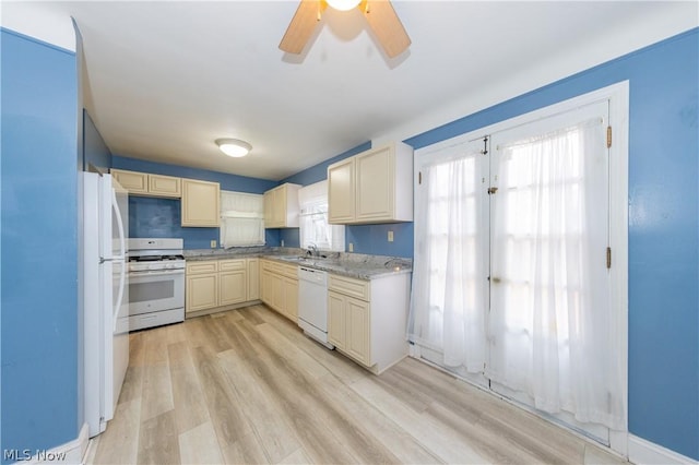 kitchen with ceiling fan, light stone countertops, sink, light hardwood / wood-style flooring, and white appliances