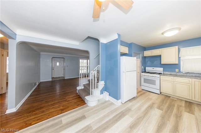 kitchen featuring cream cabinets, light hardwood / wood-style flooring, ceiling fan, and white appliances