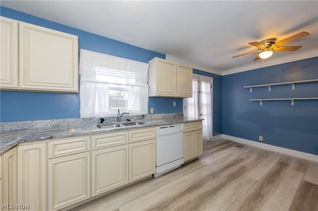 kitchen featuring cream cabinets, white dishwasher, and sink