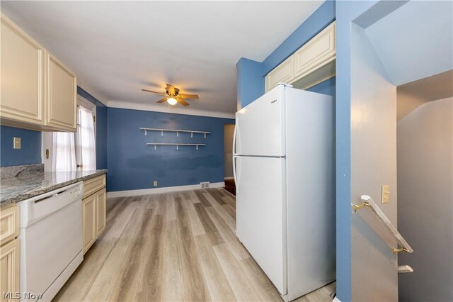 kitchen featuring cream cabinetry, white appliances, light hardwood / wood-style floors, and light stone counters