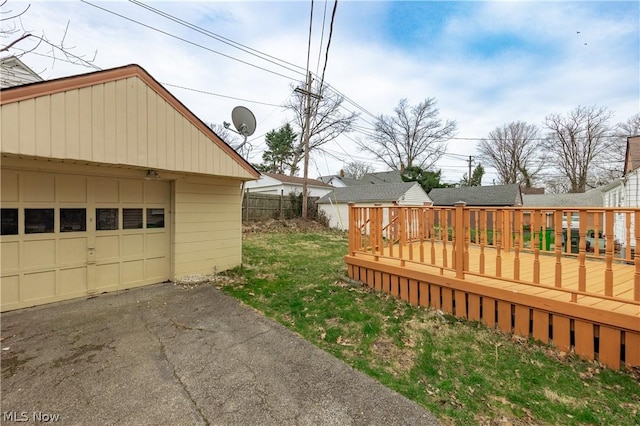 view of yard with an outdoor structure, a garage, and a deck