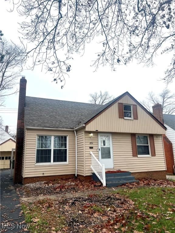 view of front of home featuring a garage and an outdoor structure