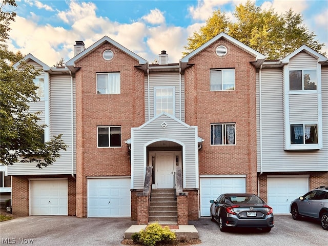 multi unit property featuring a garage