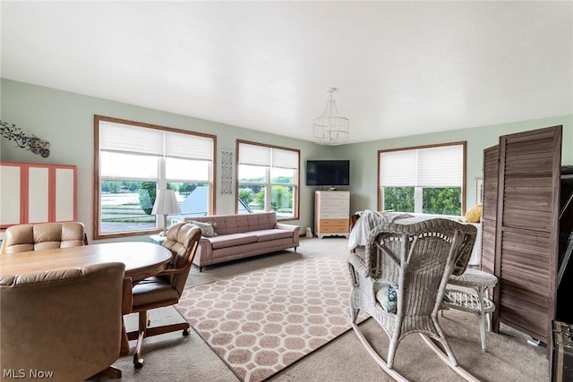 6579 Camp Blvd, Hanoverton, OH 44423 - carpeted living area featuring an inviting chandelier and a healthy amount of sunlight