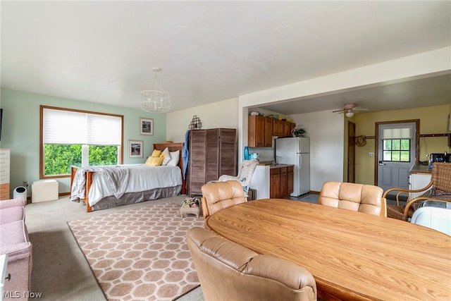 bedroom featuring carpet and white refrigerator