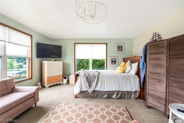 carpeted bedroom with multiple windows