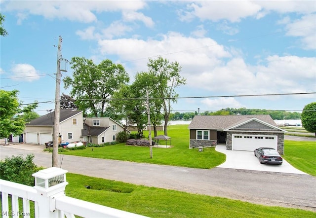 6579 Camp Blvd, Hanoverton, OH 44423 - view of front of house with an attached garage, a front lawn, concrete driveway, and stone siding