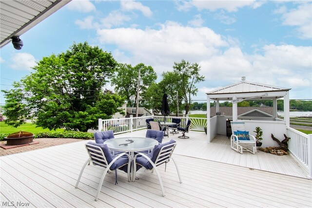 deck with a gazebo and an outdoor fire pit