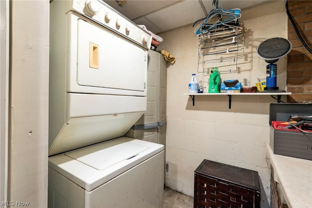 laundry room with stacked washer and dryer