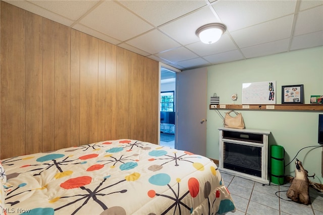 bedroom with tile flooring and a paneled ceiling