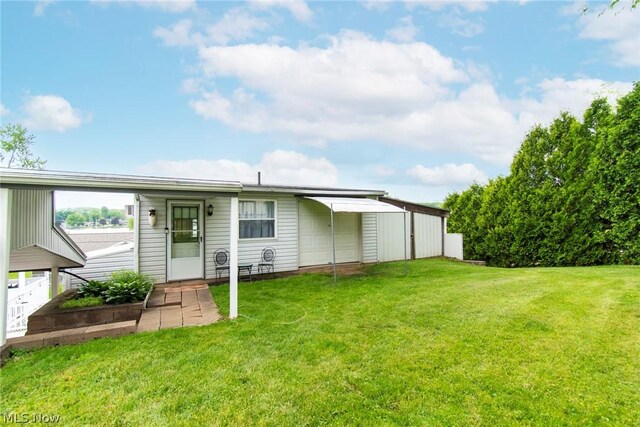6579 Camp Blvd, Hanoverton, OH 44423 - rear view of house with a yard and a garage