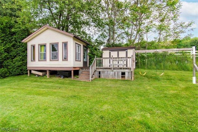 6579 Camp Blvd, Hanoverton, OH 44423 - back of house with a wooden deck, an outbuilding, and a lawn