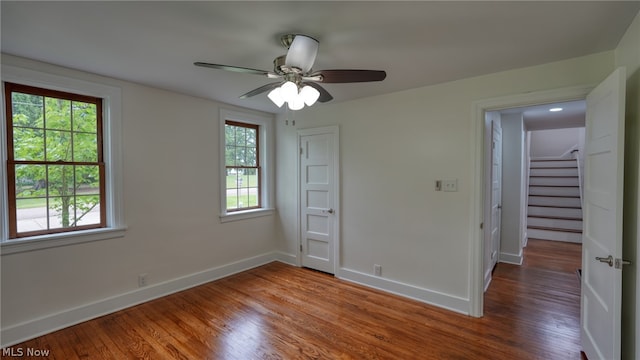 unfurnished bedroom with ceiling fan, a closet, and wood-type flooring