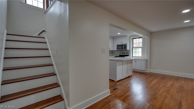 stairway featuring hardwood / wood-style floors