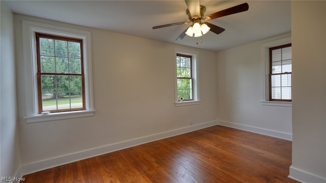 unfurnished room with ceiling fan and hardwood / wood-style flooring