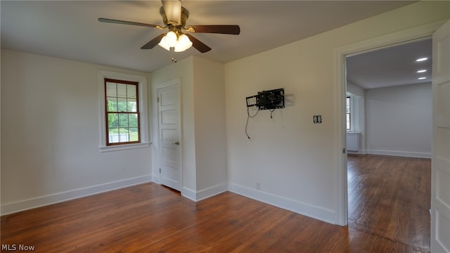 unfurnished room with ceiling fan and wood-type flooring