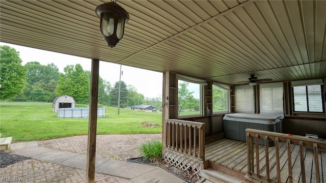 view of patio featuring a hot tub, ceiling fan, and a wooden deck