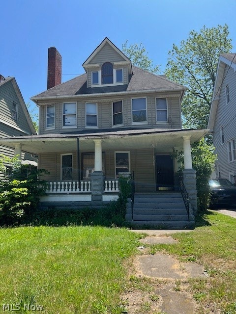 view of front of home featuring covered porch and a front yard