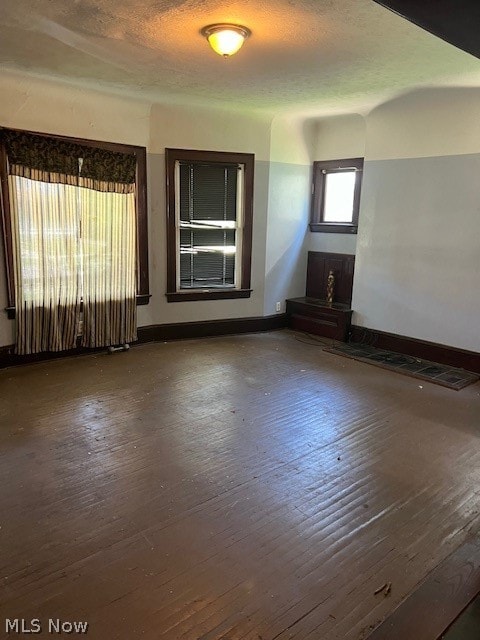 spare room with dark hardwood / wood-style flooring