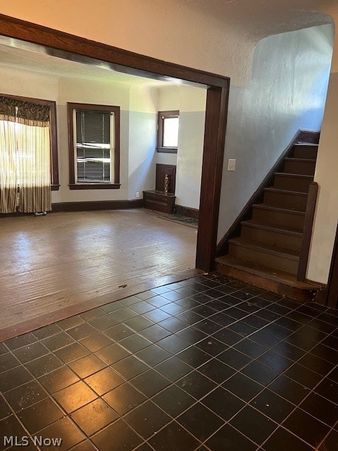 empty room featuring dark wood-type flooring and plenty of natural light