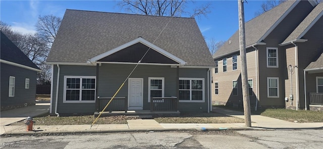 bungalow-style home with covered porch and a shingled roof