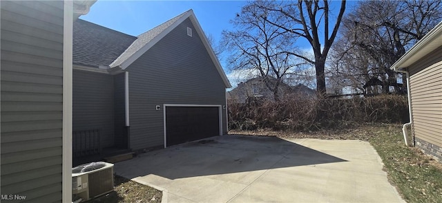 view of patio / terrace with central air condition unit and driveway