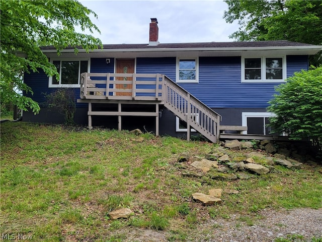 back of property featuring a wooden deck