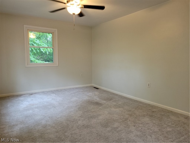 empty room featuring carpet flooring and ceiling fan