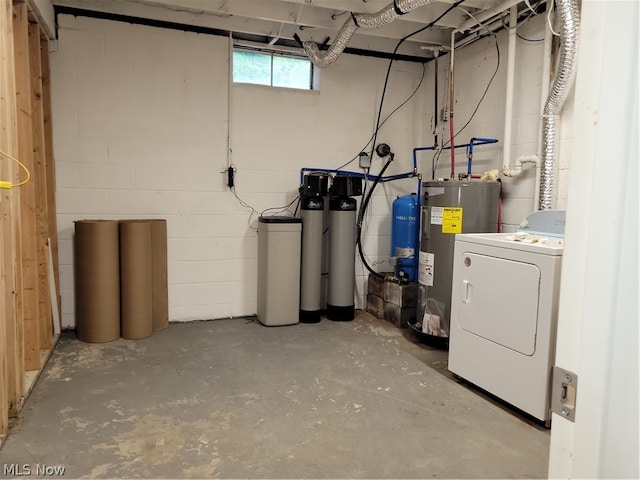 basement with electric water heater and washer / dryer