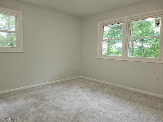 carpeted spare room with a healthy amount of sunlight