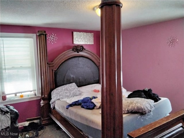 bedroom featuring carpet floors and a textured ceiling