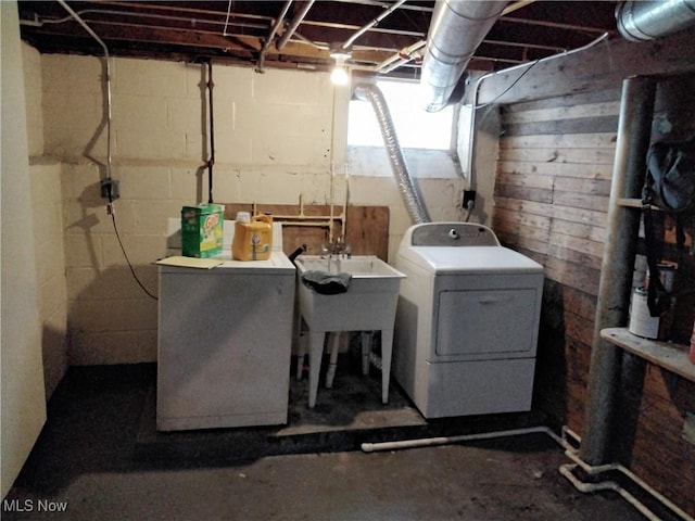 clothes washing area with sink and washing machine and clothes dryer