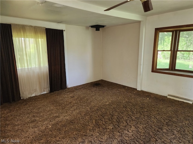 carpeted empty room featuring baseboard heating and ceiling fan