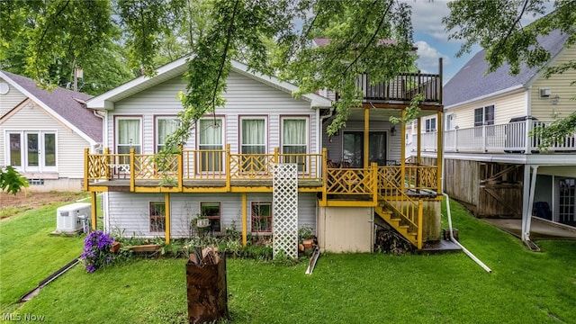 back of property featuring a deck, central air condition unit, and a lawn