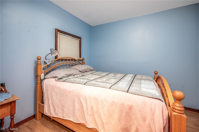 bedroom with hardwood / wood-style floors