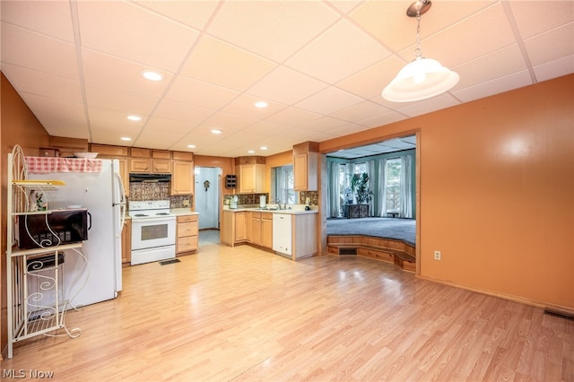 kitchen featuring light hardwood / wood-style flooring, white appliances, pendant lighting, and a drop ceiling