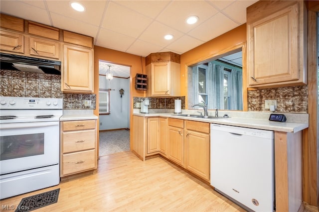 kitchen with white appliances, extractor fan, light colored carpet, a paneled ceiling, and backsplash