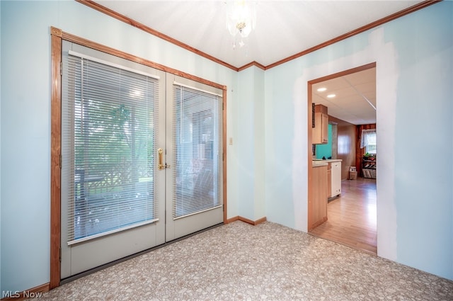 spare room featuring crown molding, hardwood / wood-style flooring, a wealth of natural light, and french doors