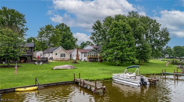 dock area with a yard and a water view