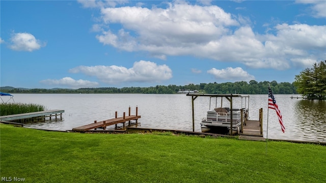 dock area featuring a lawn and a water view