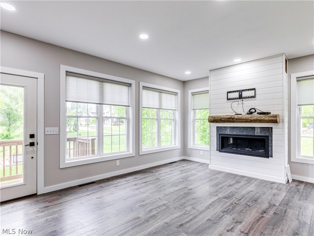 unfurnished living room with a fireplace and hardwood / wood-style floors