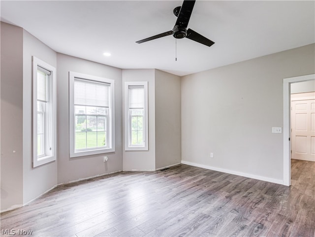 unfurnished room with ceiling fan and light wood-type flooring