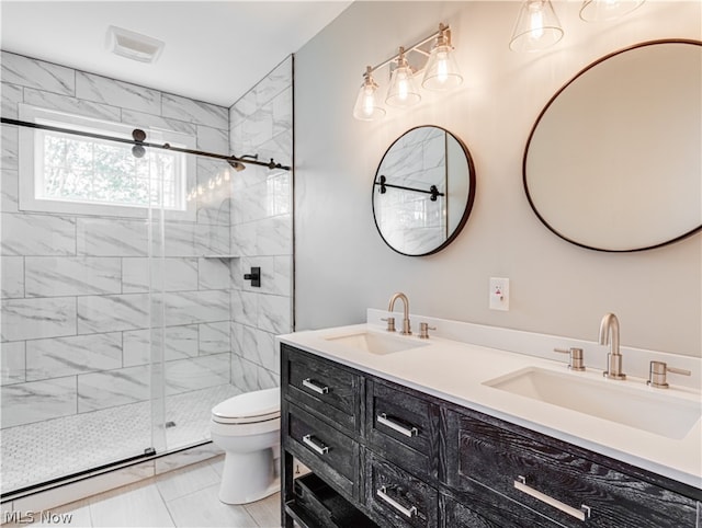 bathroom with tile patterned flooring, a shower with door, vanity, and toilet