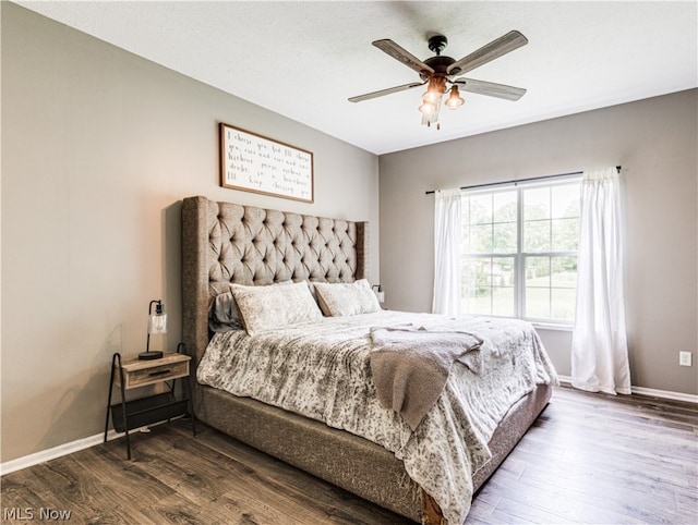 bedroom with hardwood / wood-style floors and ceiling fan