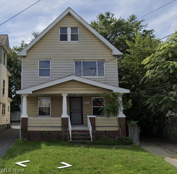 view of front of house featuring a front yard and a porch