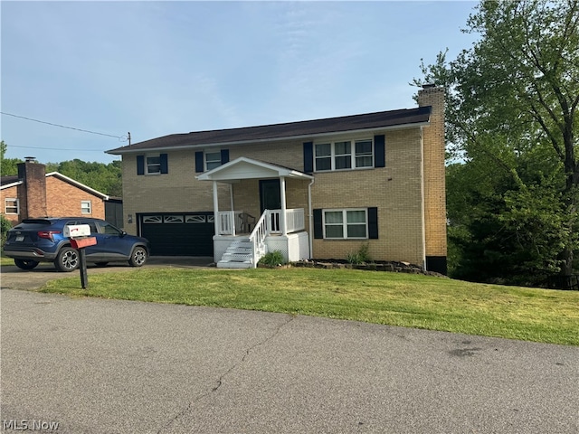 raised ranch with a garage and a front yard