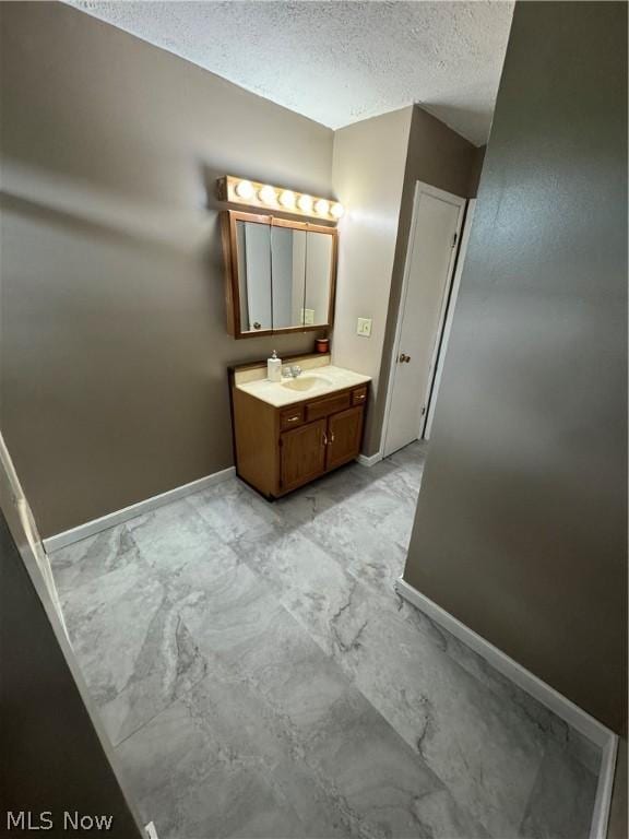 bathroom with vanity and a textured ceiling